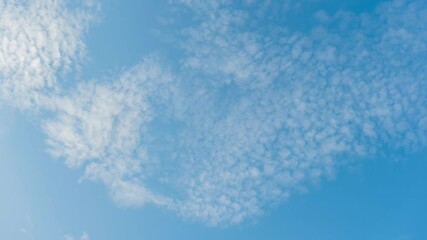 Wall Mural - blue sky with fluffy cloud time lapse on a sunny day 4k footage.