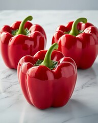 Poster - Three shiny red bell peppers on marble.