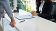 © bongkarn - A close-up image of a woman during a job interview with a male CEO in an office.