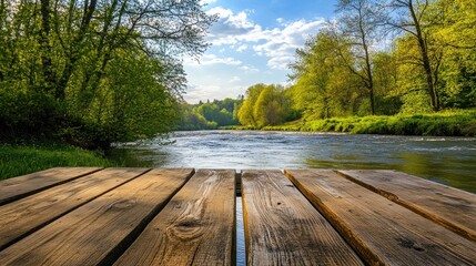 Poster - A wooden table set outdoors against a backdrop of beautiful spring scenery, with vibrant green trees, a flowing river, and a clear sky, offering a peaceful setting.