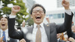 © pattozher - Triumphant Businessman: A jubilant businessman celebrates a significant achievement amidst a flurry of confetti, his infectious laughter and raised fists capturing the sheer exhilaration of success.
