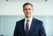 © iushakovsky - Male professional in traditional attire in a modern office setting