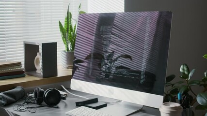 No people tilt up shot of software code running on computer screen at workplace of web data engineer in office