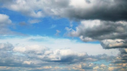 Wall Mural - Dramatic sky almost completely covered with cumulus clouds. Slowly moving huge clouds. Atmosphere before a storm or rain.