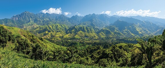 Wall Mural - Panoramic view of lush green mountains and valley under a clear blue sky.