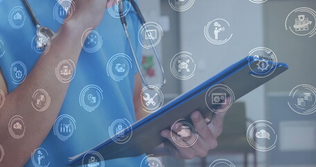 Poster - Image of business icons over caucasian female doctor writing on clipboard