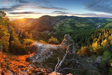 Poster - Panoramic view of mountain range under colorful blue and orange sundown in Slovakia. Rocky forest landscape
