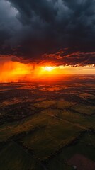 Sticker - Dramatic sunset with rain clouds over fields.