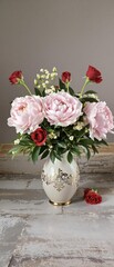 Wall Mural - A stunning arrangement of pink peonies and roses sits in a decorative vase on a rustic stone floor., flowers in vase, pink peonies, stone floor, flowers, roses