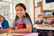 © Rido - Portrait of happy hispanic girl looking at camera in elementary classroom