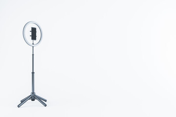 Poster - Smartphone on tripod with ring light on white background. 3D Rendering