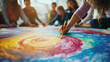 © Irina - Group art therapy Painting session with participants painting a colorful spiral on a large canvas