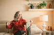 © ADDICTIVE STOCK - Woman enjoying knitting in cozy home setting