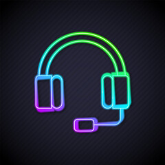Poster - Glowing neon line Headphones icon isolated on black background. Earphones. Concept for listening to music, service, communication and operator. Vector