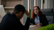 © Yuliia - Caucasian business woman businesswoman lawyer consulting African american man in office calm down client upset with high taxes bankruptcy crisis unemployment help give advice support customer service