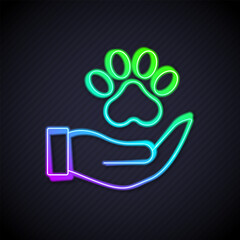 Wall Mural - Glowing neon line Hands with animals footprint icon isolated on black background. Pet paw in heart. Love to the animals. Vector