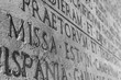 © Elena - Black-and-white close-up of an ancient Roman inscription from The Deeds of the Divine Augustus (Text of historical document of Roman Empire in Latin language). Rome, Italy