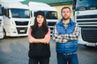 © Serhii - A woman and a man work as truck drivers. The concept of logistics and cargo delivery. In the parking lot