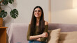 © RZ Images - Young woman smiles twirling hair and shrugging shoulders