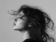 © Olga - Profile of a woman with windswept hair in a stylish black and white portrait, capturing timeless elegance and beauty.