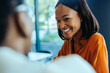 © Jacob Lund - African businesswoman smiling during a professional meeting