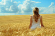 © Alberto Gonzalez  - Woman basking in the sunset in a golden wheat field
