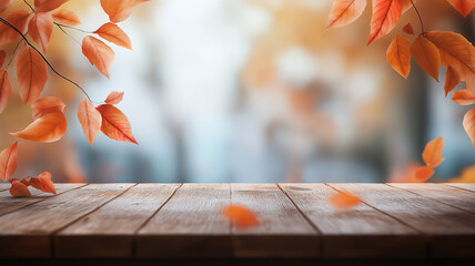 Wall Mural - Fall leaves on a wooden table with a soft-focus autumn forest in the background.