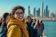 © artkozyr - Smiling young woman enjoying a sunny day near city skyline with friends in Dubai