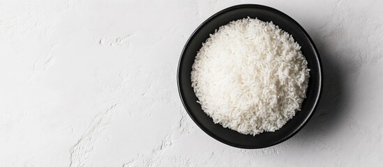 Wall Mural - Bowl of shredded coconut on white background with natural lighting and Copy Space