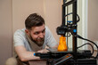 © phoenix021 - Man looking from close distance how his 3d printer works in his home