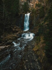 Poster - Serene waterfall in lush forest landscape.