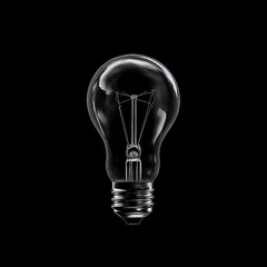 Classic lightbulb against black background