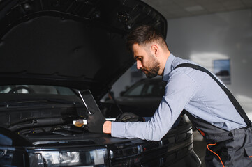 Fototapete - Troubleshooting process. Auto mechanic working in garage. Repair service