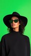 © ArtStockVault - Fashion Influencer With Sunglasses And Hat Against Green Screen For Modern Livestream Content Production And Digital Media Branding In Studio Setting Emphasizing Style And Minimalist Chic