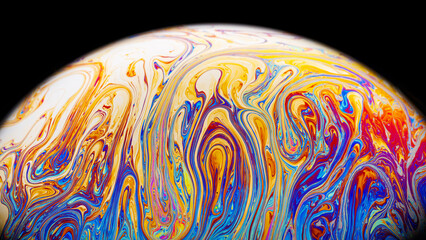 Wall Mural - Closeup on a colorful soap bubble to demonstrate thin film interference physics concept with shapes and colors always in motion
