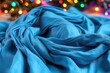 © Konstiantyn Zapylaie - Vibrant blue fabric drape with colorful bokeh lighting in background