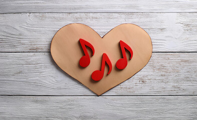 Wall Mural - Wooden Heart with Red Music Notes on White Rustic Wooden Background