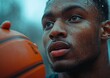 © Trollbee Production - Focused Basketball Player Holding Ball Outdoors in Intense Weather