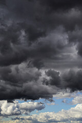 Wall Mural - Epic Dramatic storm dark cumulus rain clouds against blue sky abstract background texture, thunderstorm