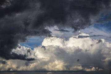 Wall Mural - Storm cloudy dramatic sky with dark rain grey and white cumulus cloud and blue sky background texture, thunderstorm, heaven