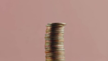 Poster - Gently placing a coin on a tall stack of coins against a vibrant pink backdrop, illustrating themes of financial growth, savings, and strategic investment opportunities