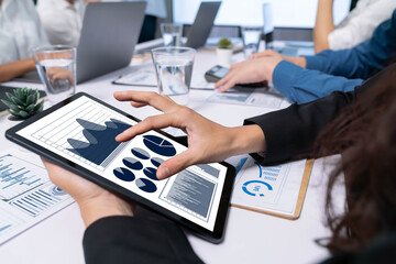 Fototapete - Analyst team uses BI Fintech display tablet to analyze financial data . Business people analyze BI software technology dashboard power for insights power into business marketing planning. Prudent