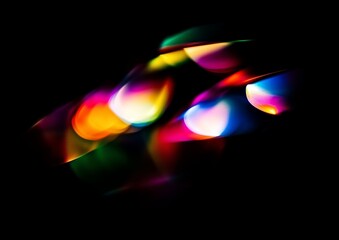 Wall Mural - Vibrant streaks of light dance across a black background, creating an abstract and colorful display.