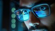 © Johannes - Young indian business man trader wearing glasses looking at computer screen with trading charts reflecting in eyeglasses watching stock trading market financial data growth concept, close up.