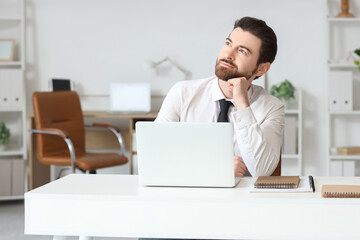 Sticker - Young businessman looking upwards at table in office