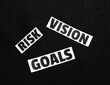 © visuals6x - Risk, Vision and Goals typography written on the paper pieces scattered, background.