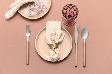 Wall Mural - Beautiful table setting with silver cutlery and gypsophila flowers on brown background