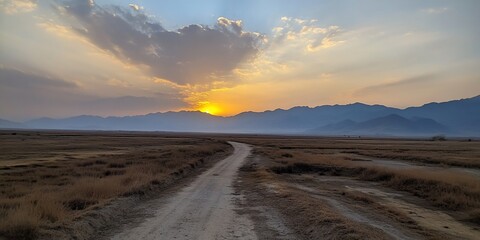 Wall Mural - Sunset over plains, dirt road, mountains. Scenic travel photo