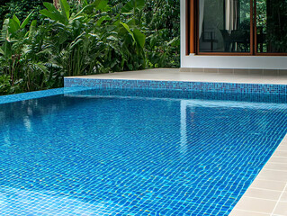 Wall Mural - Tranquil Blue Mosaic Tile Swimming Pool Adorned with Lush Greenery Creates a Serene Oasis