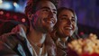 © AounMuhammad - A joyful couple enjoying a movie together, sharing smiles and popcorn in a dimly lit cinema.